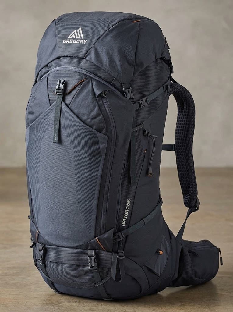 A dark Gregory backpack marked Baltoro 65, with a top lid and padded hip belt.